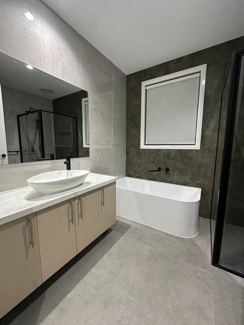 Stone bathroom with a freestanding bath and vanity from Lamassu’s project portfolio